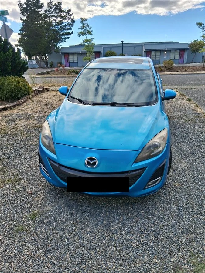 2010 Mazda 3, blue hatchback, front view